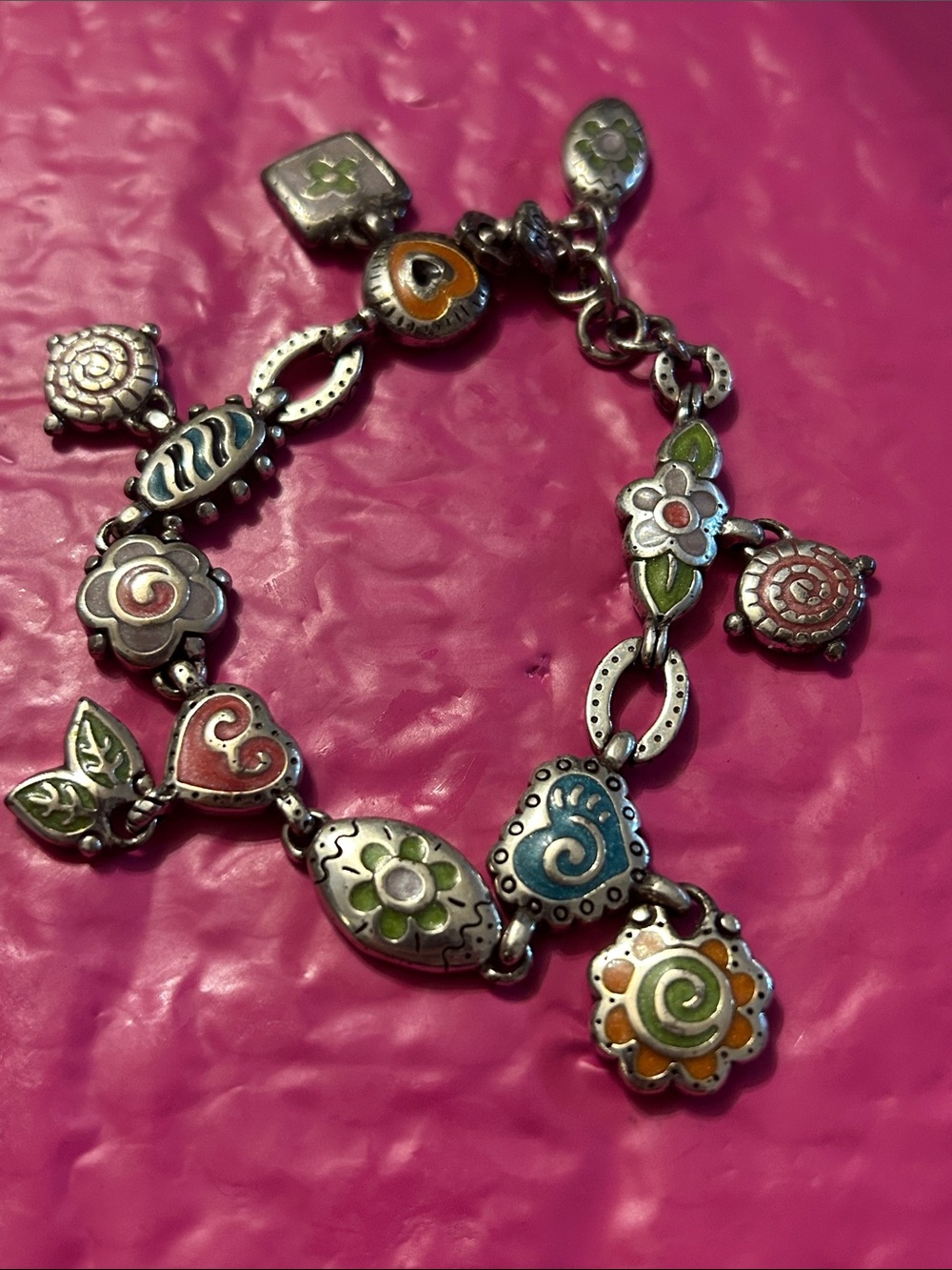 Brighton charm bracelet decorated with colorful enameled floral/heart charms